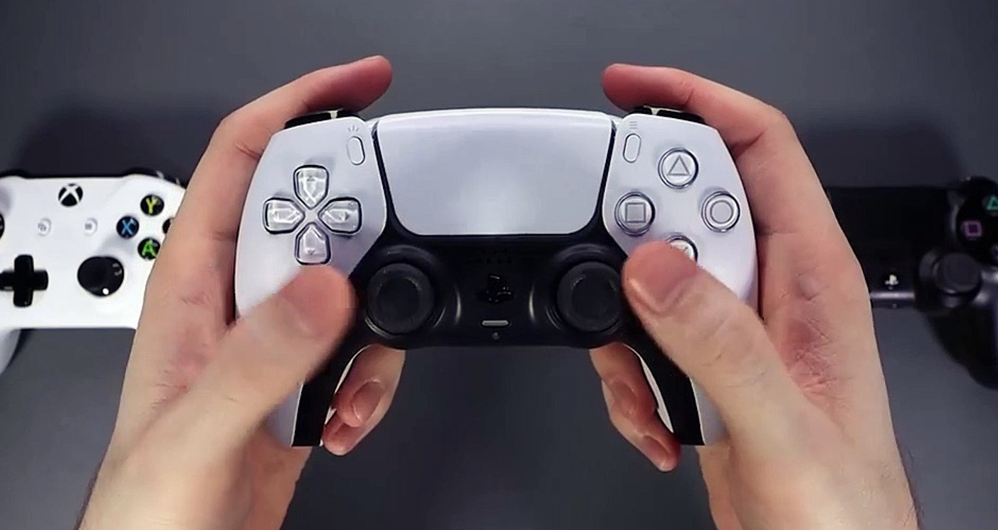 holding ps5 controller with ps4 controller in background